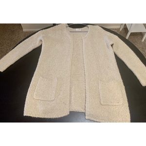 An oversized cream colored fur cardigan